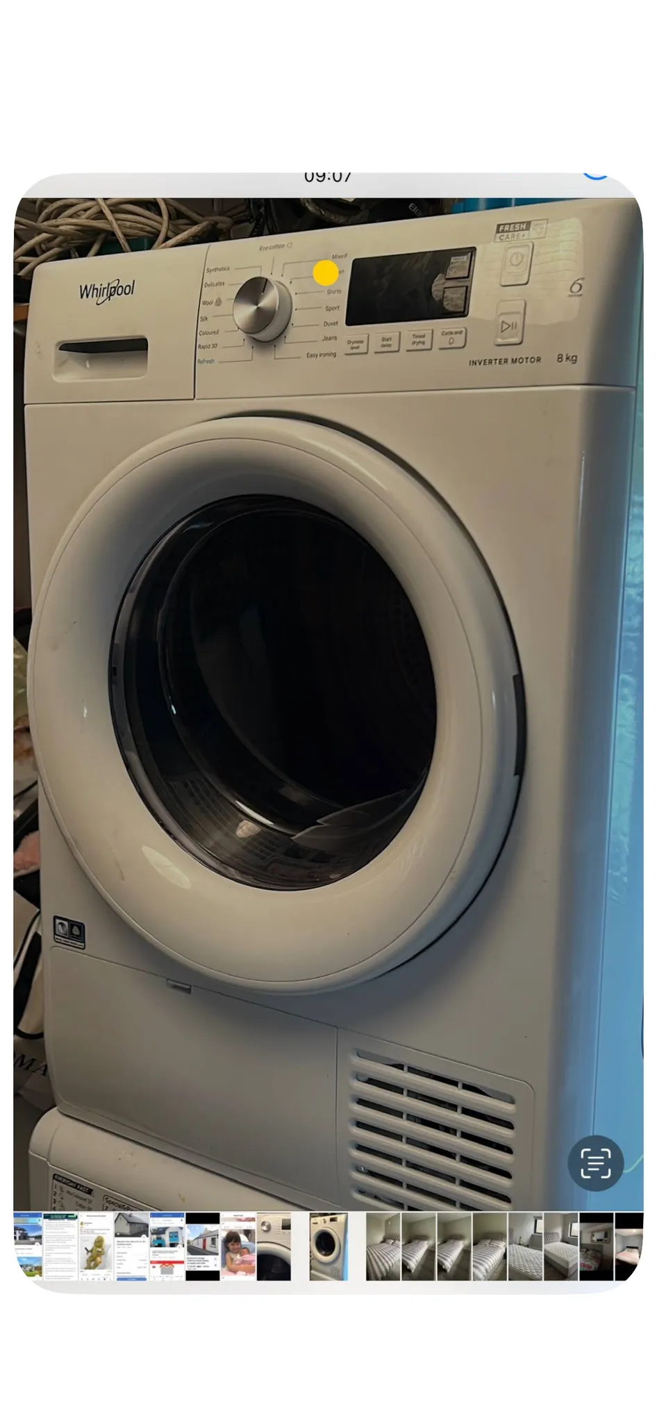 Front-loading Whirlpool washing machine with round door and control panel visible