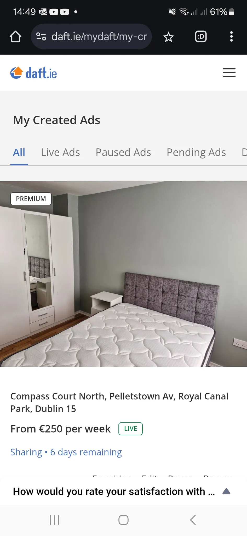 Bedroom with a double bed and upholstered headboard, mattress, small bedside table and a white wardrobe with mirrored door; photo shown as a screenshot of a listing page.